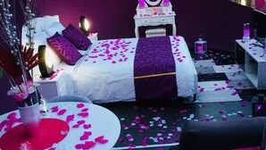 A tented accommodation with a bed, bedside table, and a mirror. - La Bulle Des Anges (Illoud)