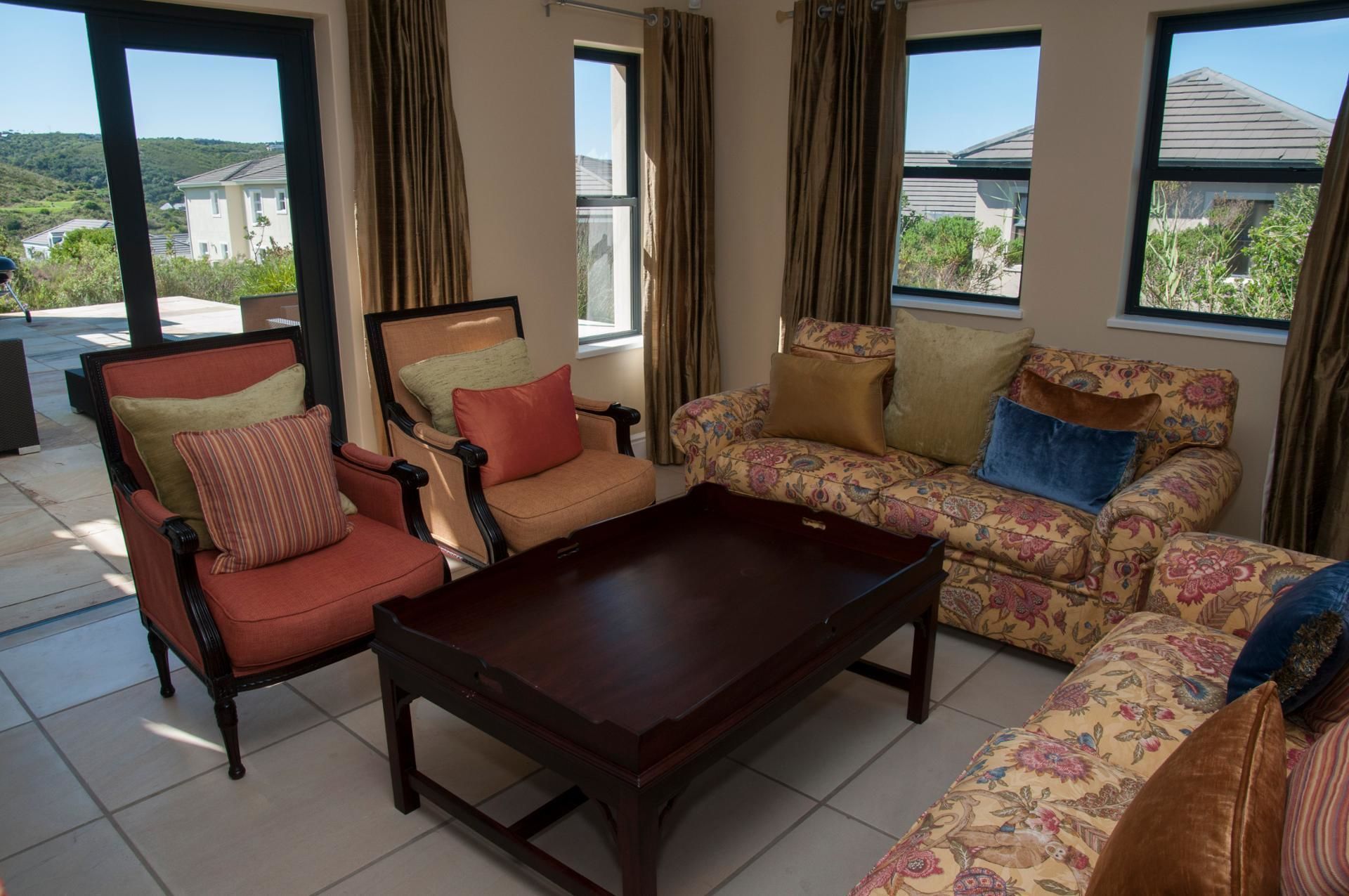 A living room with a sofa, armchair, and coffee table.