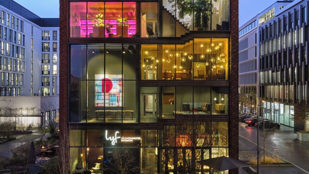 A modern building with multiple floors, large glass windows, and a rooftop garden. - lyf East Frankfurt (Frankfurt)