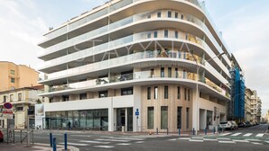 A multi-story building with a curved facade, large windows, and balconies. - Boutique 2 bedroom apartment VRBO (Nice)