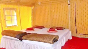 A room with a bed, pillows, and a window. - Kumbh Luxury Tents (Prayagraj)