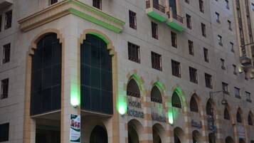 A hotel with a classic architectural style, featuring arched windows and balconies.