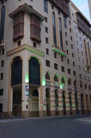 A hotel with a classic architectural style, featuring arched windows and balconies.