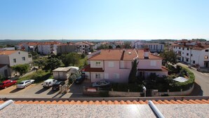 A residential area with multiple houses, a parking lot, and a clear sky. - Apartments Elida (Rovinj)