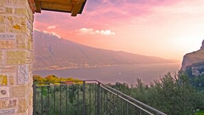 A balcony with a view of a lake and mountains.