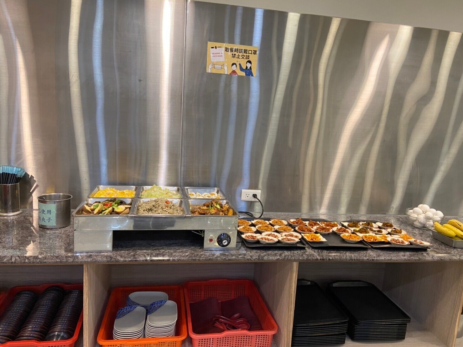 Een buffetopstelling met diverse gerechten en bijbehorende sauzen.