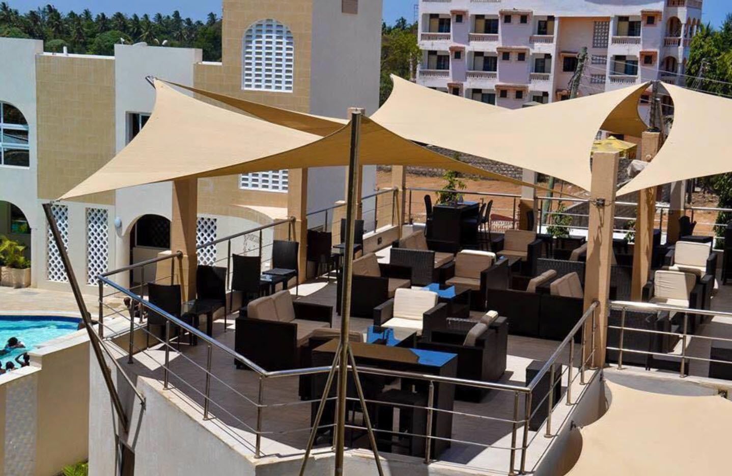 A rooftop lounge area with outdoor seating and a pool.