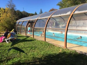Une piscine couverte où l’on peut nager et se détendre au bord.
