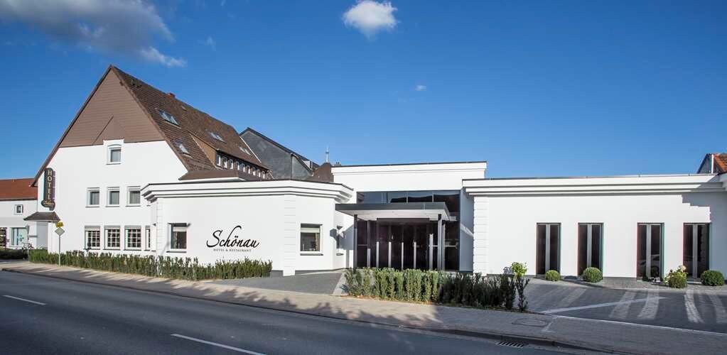 A hotel with a modern design, featuring a prominent entrance and a sign that reads "Schloss."