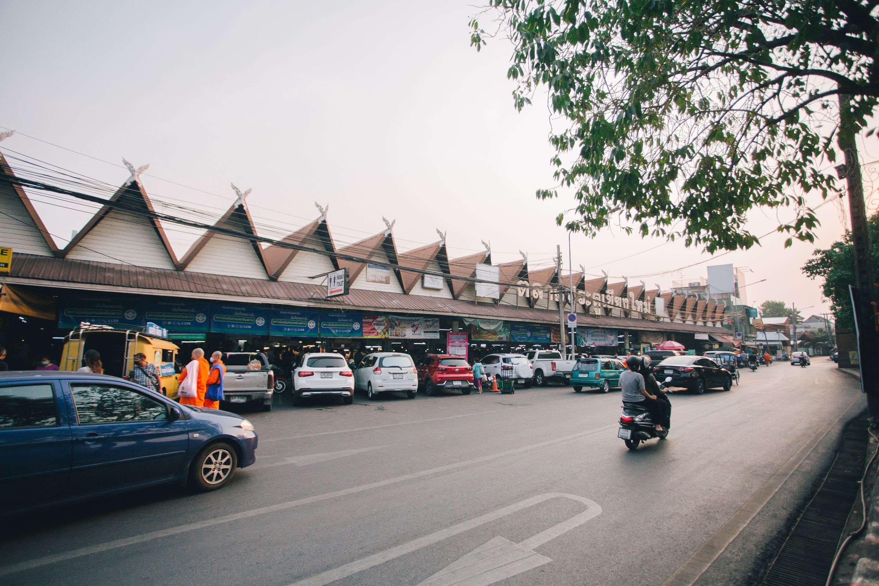 A street scene with buildings, cars, and people.
