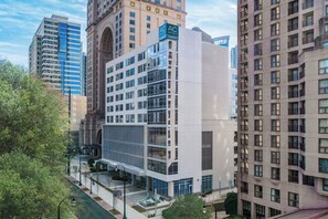 A modern hotel with a glass facade, multiple floors, and a prominent AC Hotels Marriott sign. - AC Hotel by Marriott Atlanta Midtown (Atlanta)