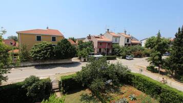 A residential area with houses, a road, and greenery.