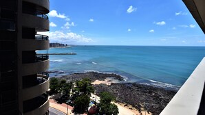 A coastal view from a high-rise building with balconies overlooking a beach and ocean. - SEAFLATS Villa Costeira (Fortaleza)