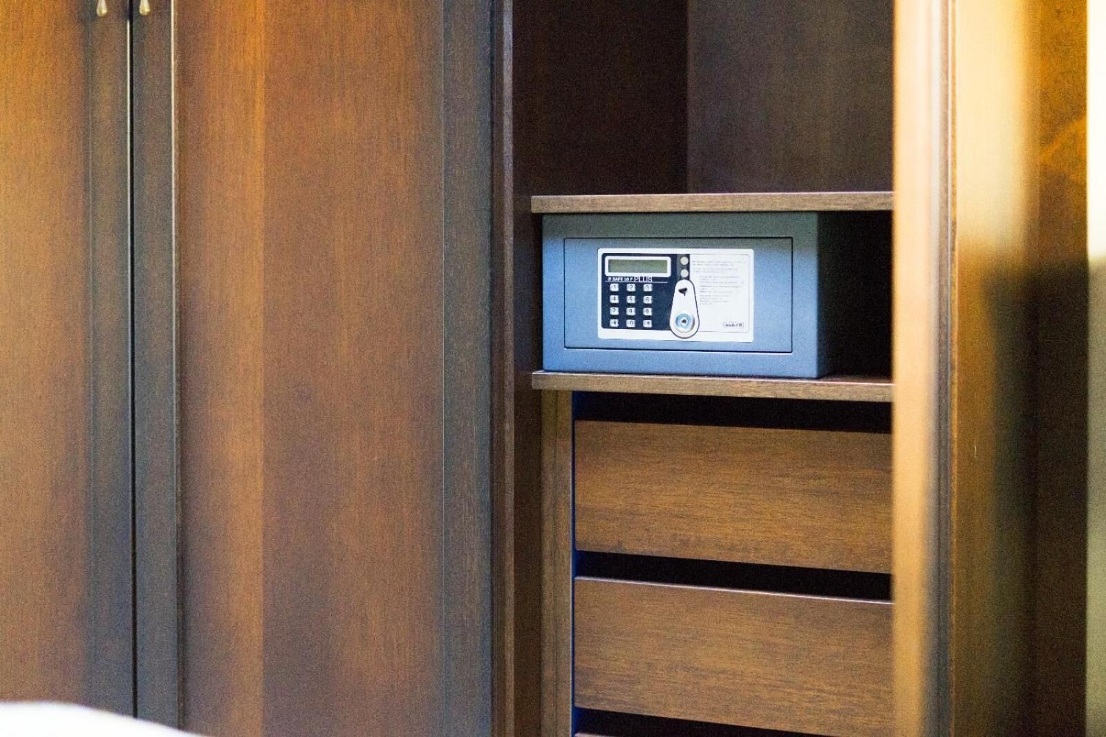 A wooden cabinet with a built-in electronic device, possibly a safe or security system.