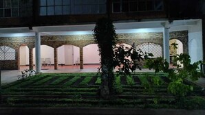 A building with a courtyard, brick arches, and a well-maintained garden. - Hotel Lakeside (Anuradhapura)