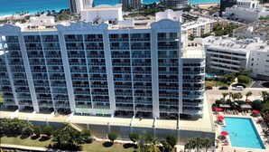 A high-rise hotel with multiple balconies, a swimming pool, and a view of the ocean. - Le Marina Bay 1006 STR-01435 (Sunny Isles Beach)