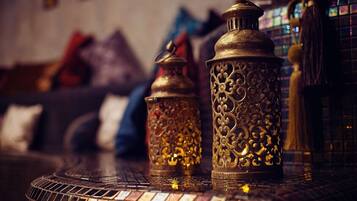 Two ornate metal lanterns on a tiled table.