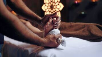 A person receiving a massage with a focus on their hands and feet.