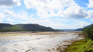 A wide, open landscape with a river or lake, distant hills, and a clear sky. - Shelduck Cottage, shoreline location, pet friendly, sleeps 7 (Glendaruel)