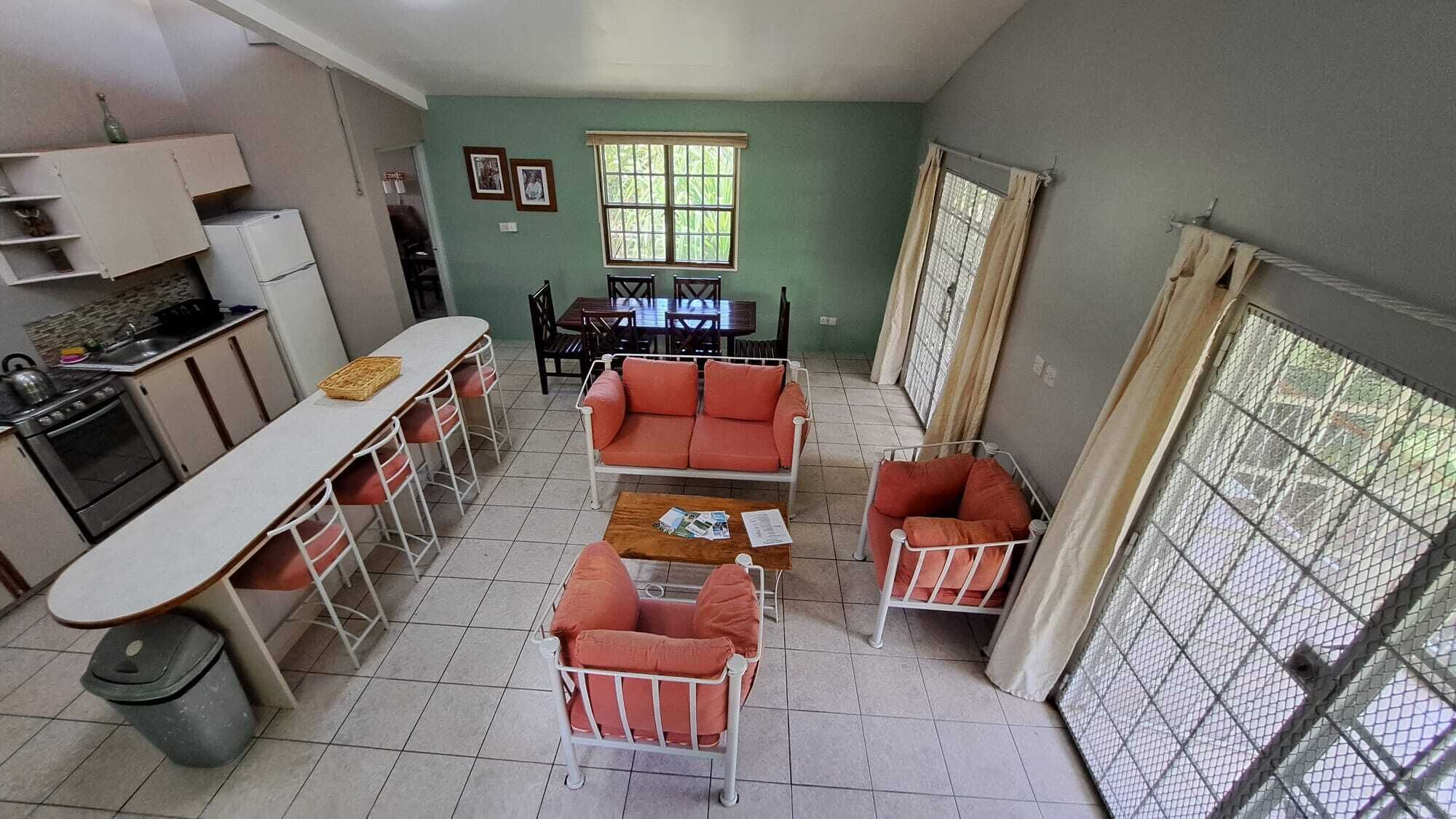 A compact living space with a kitchenette, dining area, and seating arrangement.