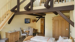 Ein Schlafzimmer mit Bett, Schreibtisch, Stuhl und Fernseher.