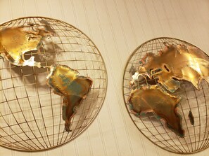 Two decorative glass globes with a wireframe design, placed on a textured surface.