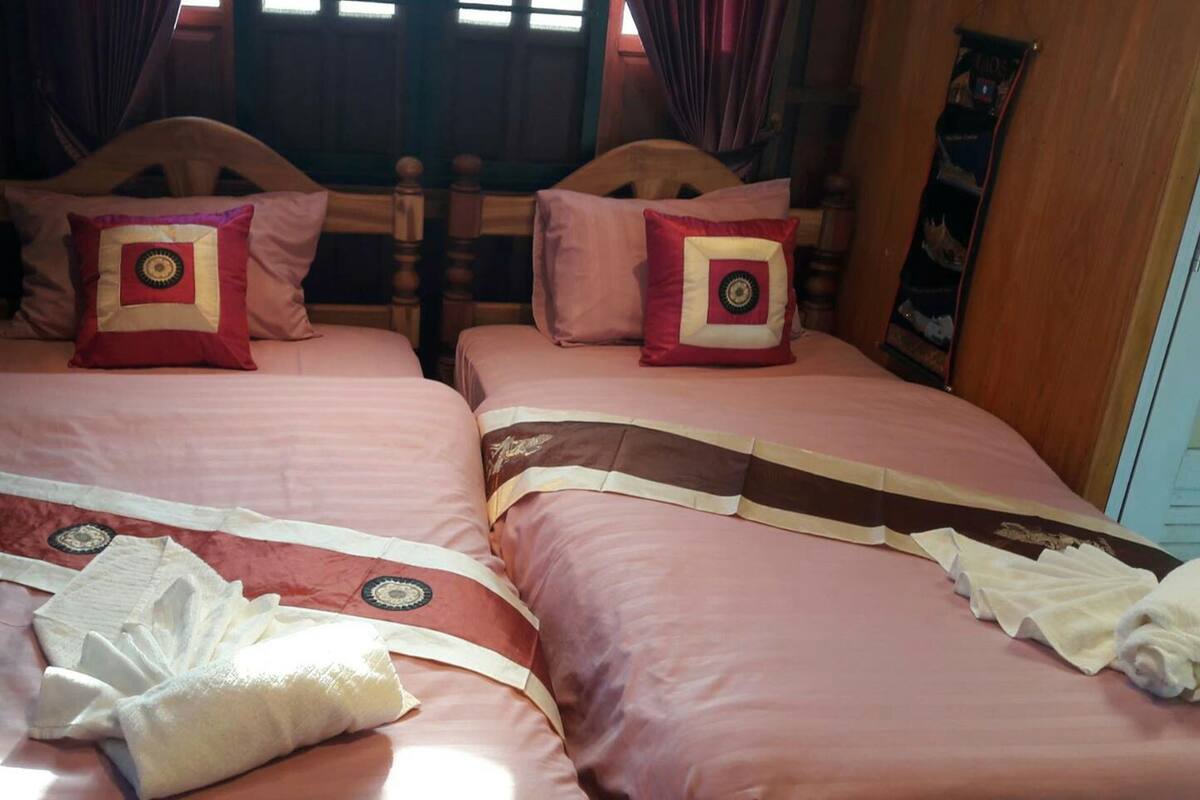 A double bed with matching pillows and a decorative bedspread.