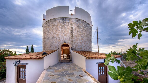 A stone tower with a tiled roof, a stone-paved entrance, and a view of the sky. - KOKKINO KASTRO is a historic estate in Aegina full of memories from 1825. (Aegina)
