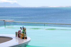 Outdoor pool, an infinity pool - LUXURIOUS SELF CATERING PENTHOUSE - ENTIRE TOP FLOOR WITH SEA VIEW (Gordons Bay Central)