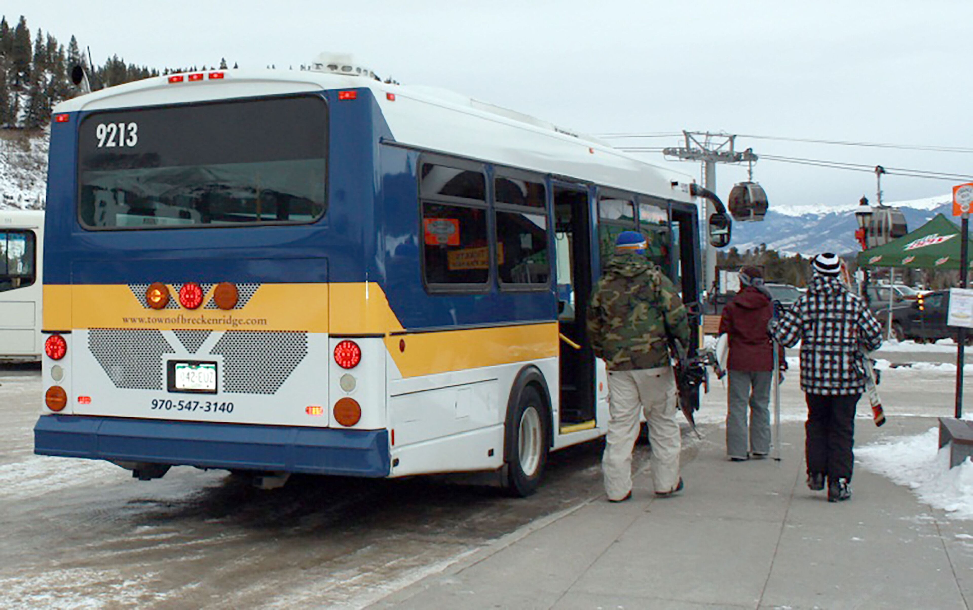 A bus with the number 9213 parked on a snowy road.