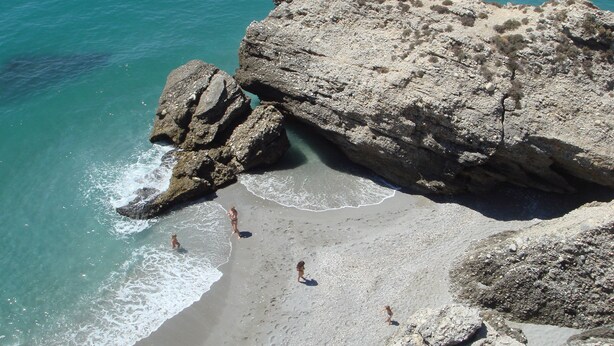 A rocky beach with clear turquoise water and a large rock formation. - Location, location, location! Front line beach with all Nerja amenities to hand. (Nerja)