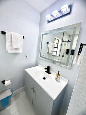 Shower, hair dryer, towels, shampoo