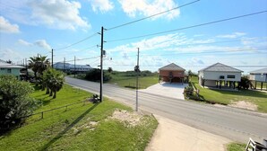 A rural road with a small building labeled 'BREAKAWAY' and a few houses in the background. - Blue Water Villa B - Coastal Realty Group (Grand Isle)