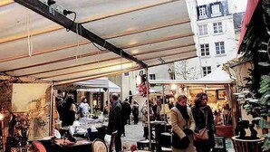 An outdoor market with tables and chairs under a tent. - Saint Paul, Marais History France Louis XIV &XV (Paris)