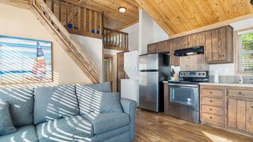 A modern kitchen with wooden cabinets, a stainless steel refrigerator, and a built-in oven.