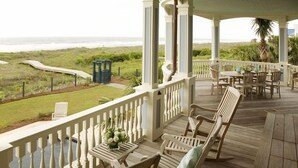 A covered outdoor area with wooden furniture and a view of the beach. - Memory Making Oceanfront, 5BR/5BA Mansion, Pool (Isle of Palms)