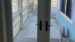 A view from inside a room with a door leading to a balcony overlooking a beach. - Memory Making Oceanfront, 5BR/5BA Mansion, Pool (Isle of Palms)