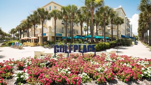 A hotel named "GULF PLACE" with a sign in the foreground, surrounded by palm trees and flower beds. - Gulf Views!/corner unit/deeded beach access/pickleball courts (Santa Rosa Beach)