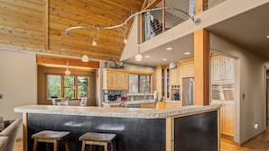 A spacious kitchen with a large island, wooden cabinets, and a mezzanine level. - Pet-Friendly Mountain View Retreat | Near Lake & Trails | Rec Center Access (Truckee)