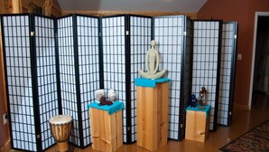 A room with a traditional Japanese shoji screen divider, a small drum, and a statue on a wooden stand. - Nicely Appointed Cabin in Scenic Setting. Family-friendly, Romantic Too!  (Arrington)