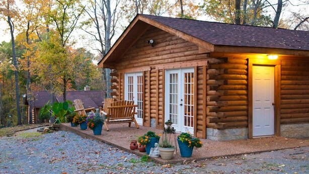 A log cabin with a porch, a bench, and potted plants. - Nicely Appointed Cabin in Scenic Setting. Family-friendly, Romantic Too!  (Arrington)