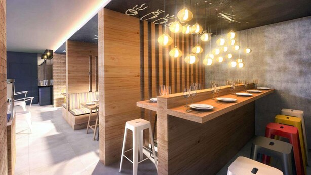 A modern kitchen with a wooden island, bar stools, and pendant lighting. - Comfort Hotel Maceio (Maceió)