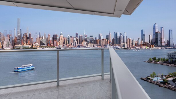 A balcony with a city skyline view, a body of water, and a boat. - Envue, Autograph Collection (Weehawken)
