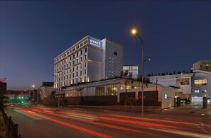 Situated on a bustling street, the Hyatt Regency hotel offers a striking night view.