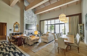 Relax in style with a comfortable seating area, dining table, and fireplace.