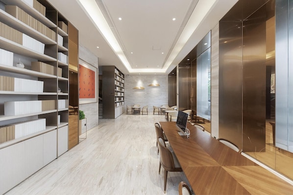 A modern conference room with a long wooden table, chairs, and built-in bookshelves. - Ji Hotel (Huai'an)
