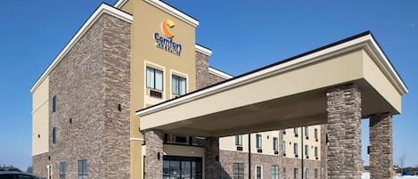 Stunning hotel building with a covered entrance and stone pillars.