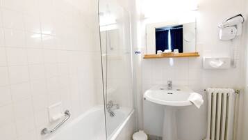 A modern bathroom with a glass-enclosed shower, a pedestal sink, and a built-in mirror above the sink.