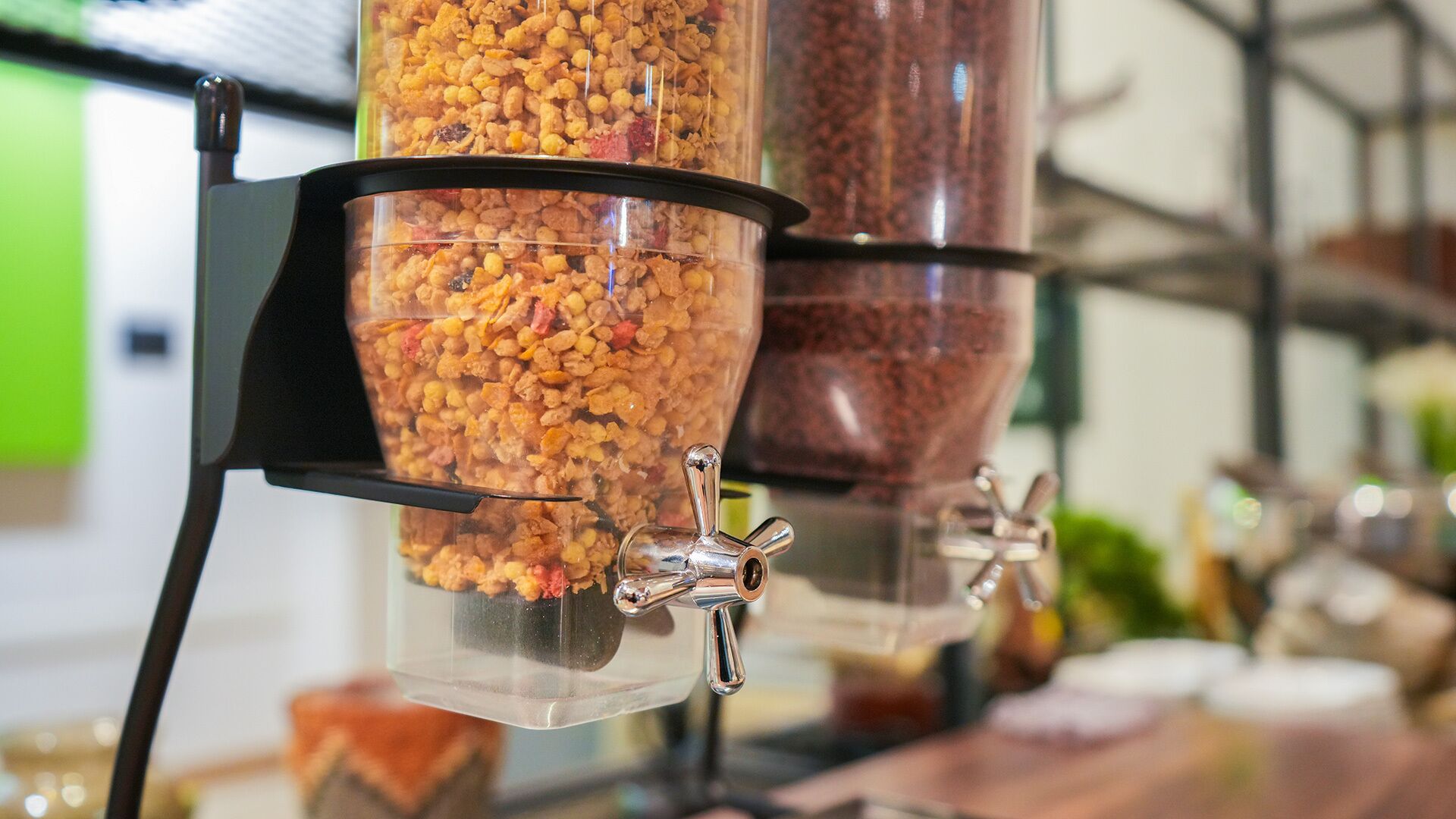 A food dispensing station with multiple containers filled with different types of snacks.