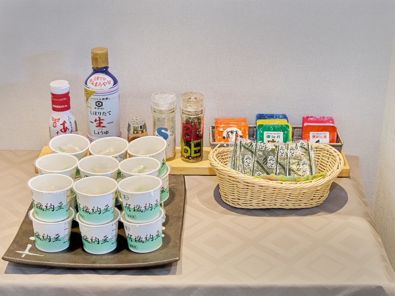A table with various food items, including packaged snacks, condiments, and a basket of packaged goods.